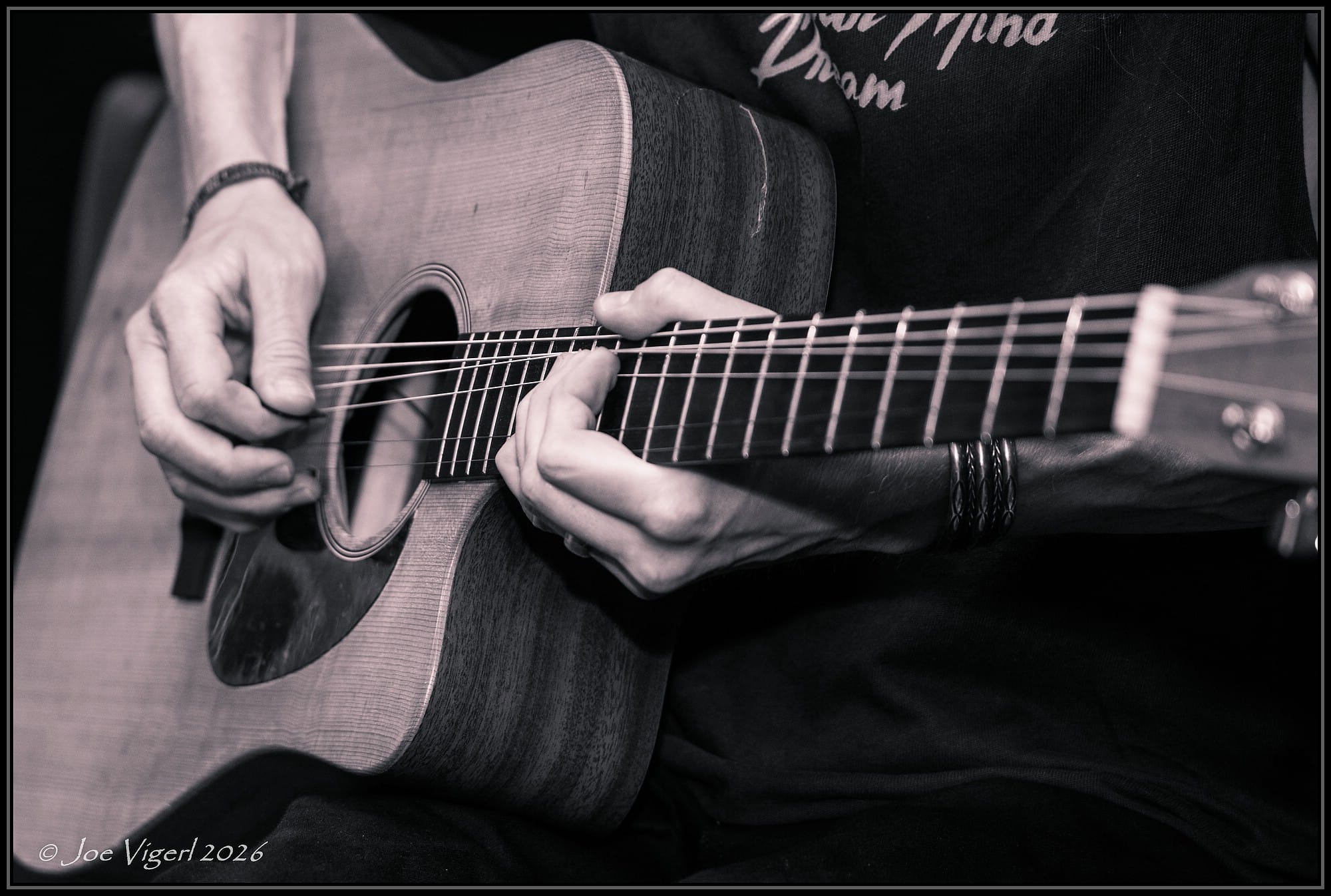 Close-up of acoustic guitar fingerpicking